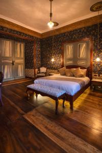 1 dormitorio con cama y banco. en Casa Bolívar Hotel Museo, en Loja