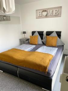 a bedroom with a large bed with yellow pillows at Innenstadt Neumarkt-Schildergasse stylische Wohnung in Cologne