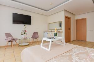 a living room with a tv and a table at Palanga Center Studios in Palanga