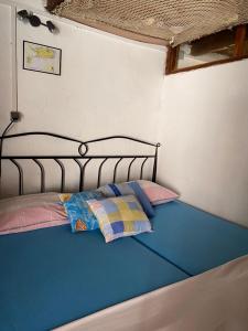 a bed with two pillows on it in a room at Holiday home Stiniva in Vis