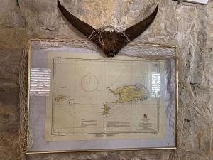 a butterfly on top of a map on a wall at Holiday home Stiniva in Vis