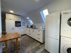 a kitchen with a white refrigerator and a table at Grüner Baum in Langenbrand