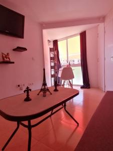 a living room with a table with a tableablish at Studio Petit Amour in Sitio de Calahonda