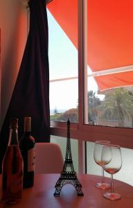 a table with two wine glasses and a eiffel tower on it at Studio Petit Amour in Sitio de Calahonda +10 photos