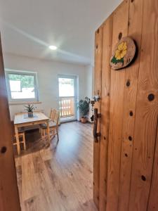 an open door to a dining room with a table at TriSa apartments Bohinj in Bohinj