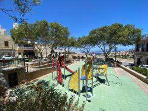 a park with a playground with a slide at Sunshine Apartments Mellieha - modern three bedroom apartment - Apt No 2 in Mellieħa