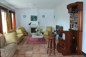 a living room with a couch and a table at Bella Italia Pópulo Guest House in Ponta Delgada