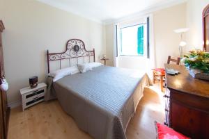 a bedroom with a large bed and a window at H11 SEA UNDER THE HOUSE - Arma di Taggia - Liguria in Taggia