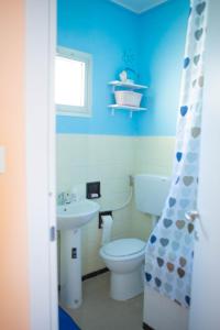 a blue bathroom with a toilet and a sink at H11 SEA UNDER THE HOUSE - Arma di Taggia - Liguria in Taggia