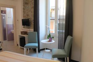 a bedroom with two chairs and a table and a window at Marianna Quiet Rooms in Monterosso al Mare