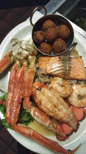 a plate of food with shrimp and other foods at The Otter Lodge in Ottertail
