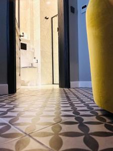 a bathroom with a tile floor and a yellow surfboard at Casa Reale Boutique Hotel in Valletta