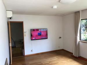a room with a flat screen tv on a wall at Trust Maison Nishiizu - Vacation STAY 68007v in Ukusu