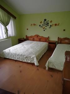 a bedroom with two beds and a window at Вилно селище Св. Георги Победоносец in Tsigov Chark