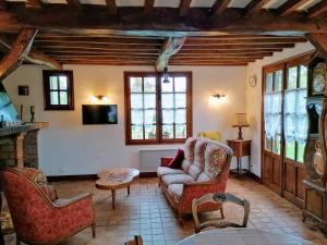 a living room with a couch and chairs and a tv at Maison entière la longe'yeres in Saint-Martin-le-Gaillard