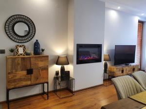 a living room with a flat screen tv on a wall at Monteverde Ski Lift Apartment Bansko in Bansko