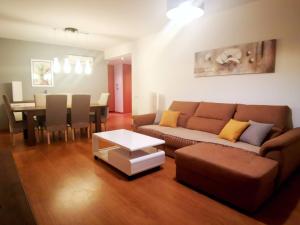 a living room with a couch and a table at Terraços do Rio in Portimão