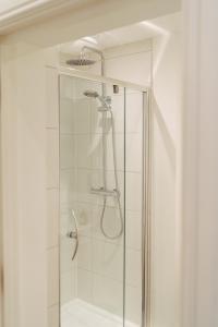 a shower with a glass door in a bathroom at York Riverside Apartments in York