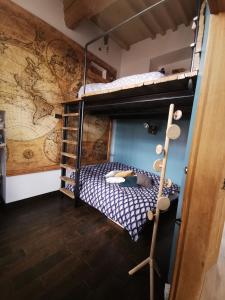 a room with a bunk bed with a map on the wall at B&B A la Ferme d'Ourches in Cerville