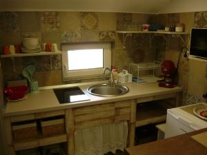 a kitchen counter with a sink and a window at CASA DE OASPETI LIVIU in Praid +35 photos