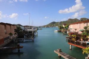 a marina with houses and boats in the water at A Beautiful villa in a prime location of Jolly in Jolly Harbour