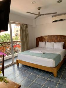 a bedroom with a bed and a balcony at CASA BARKA in Playa del Carmen