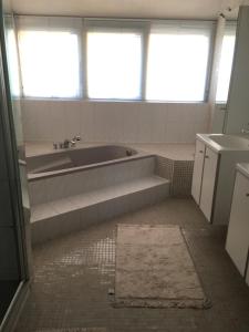 a bathroom with a bath tub and a sink at Stadslogement Hellevoetsluis in Hellevoetsluis