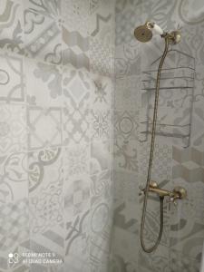 a bathroom with a shower with gray and white tiles at Casa Pastor, Delta del Ebro in El Lligallo del Gànguil