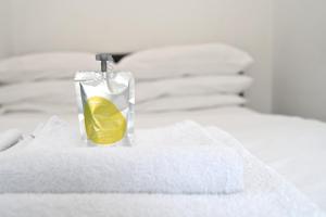 a bottle of soap sitting on top of a bed at D'Arblay Studio's Soho in London