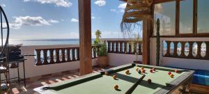 a pool table in a room with a view of the ocean at GOLVEN Surf in Taghazout