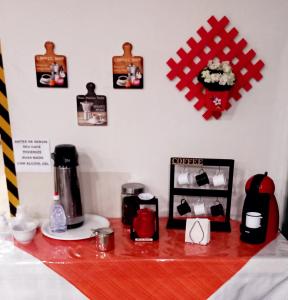 a counter with a coffee maker on a table at Hotel Excelsior in Poços de Caldas