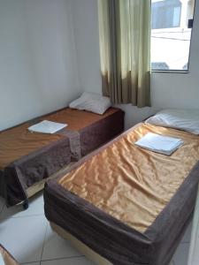 two beds sitting in a room with a window at Brasil mulato in Salvador