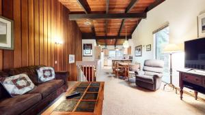 a living room with a couch and a table at Mammoth West #101 Condo in Mammoth Lakes