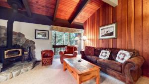 a living room with a couch and a fireplace at Mammoth West #101 Condo in Mammoth Lakes