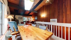 a dining room with a wooden table and chairs at Mammoth West #101 Condo in Mammoth Lakes