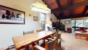 a dining room with a wooden table and chairs at Mammoth West #101 Condo in Mammoth Lakes