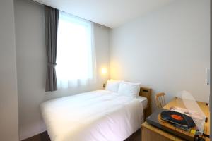 Postel nebo postele na pokoji v ubytování MUSTARD HOTEL SHIMOKITAZAWA