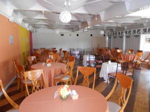 a dining room with tables and chairs and a room with tables and chairsktop at The Villa Hamanako in Kosai