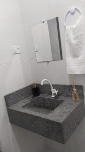 a bathroom counter with a sink and a mirror at Pousada Águas da Chapada in Carolina +19 photos