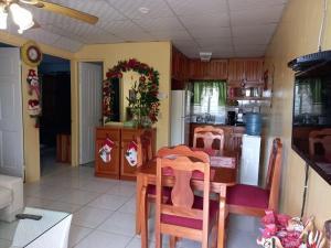 a kitchen with a table and a dining room at Nicol Aparment in Bocas del Toro