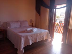 a bedroom with a bed with two towels on it at Residencia Sao Miguel in Tiradentes