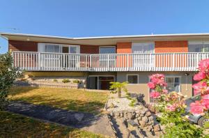 an exterior view of a house with a balcony at Spacious Utuhina holiday House in Rotorua