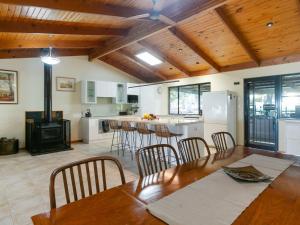 a kitchen and dining room with a table and chairs at Lot 4 Retreat 150 Willson Drive in Normanville +20 photos