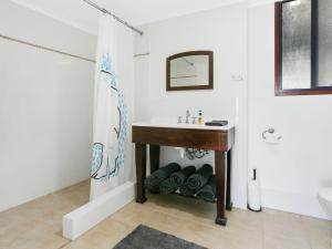 a bathroom with a sink and a mirror and a sink at Lot 4 Retreat 150 Willson Drive in Normanville