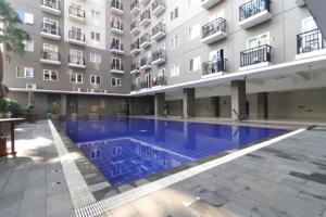 a swimming pool in front of a building at Adaru Property at Sunter Park View in Jakarta