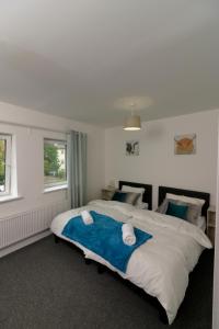 a bedroom with a large bed with two pillows at Canal View Apartment in Bletchley