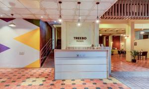 an office lobby with a firenos sign on the wall at Treebo Trend Iris Suites in Pune