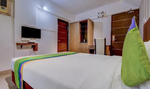 Postel nebo postele na pokoji v ubytování Treebo Iris Suites