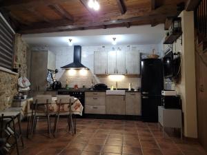 a kitchen with a table and a black refrigerator at La Cantina in Chanos