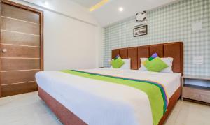 Postel nebo postele na pokoji v ubytování Treebo Iris Suites